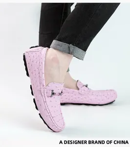 Close-up of pink ostrich texture men's loafers with metal buckle