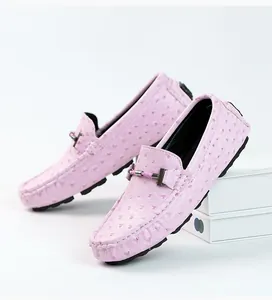Close-up detail of pink ostrich-texture leather loafers for men with metal bit