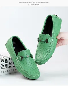 Detailed close-up of green ostrich leather loafers featuring a stylish metal bit.