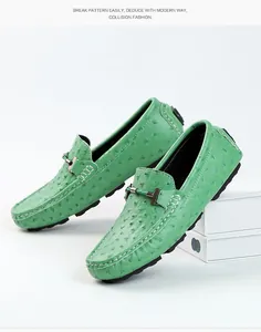 Close-up of green men's loafers with ostrich skin texture and metal buckle