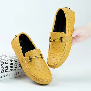 Yellow ostrich textured men's leather loafers with H-buckle and decorative cord.
