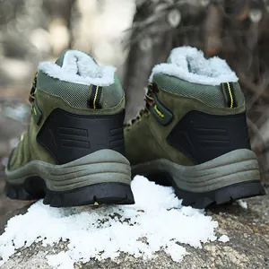 Rear view of olive green high-top snow boots with warm white faux fur lining on snow