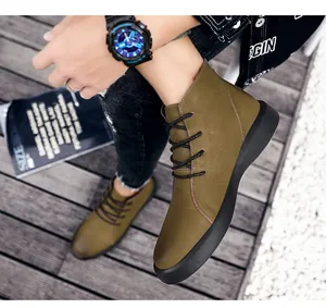 Detail shot of men's leather outdoor boots with black laces and thick soles.