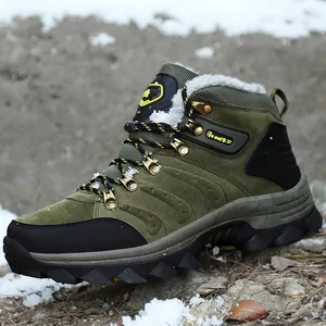 Professional side view of green waterproof hiking boots with warm fur lining in snowy terrain.