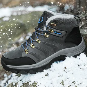 Close-up of a warm grey high-top winter boot with faux fur lining in snow