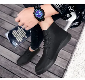 Perspective view of men's black high-top genuine leather work boots worn on model's feet