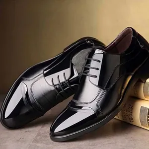 Detailed side view of glossy black men's business leather shoes with laces