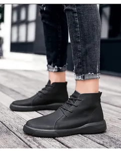 Detail view of men's black genuine leather high-top boots for outdoor casual wear.