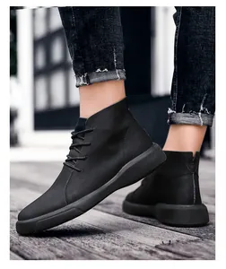 Close-up detail of black high-top leather boots for men featuring textured pebble leather