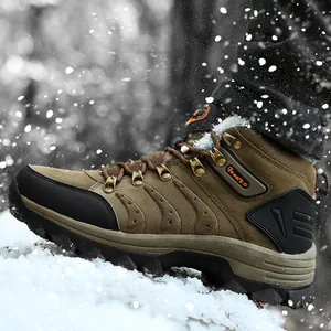 Detailed side view of brown waterproof snow boots stepping on fresh snow in winter woods