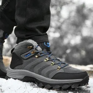 Detailed view of grey waterproof winter hiking boots with warm faux fur lining on snow