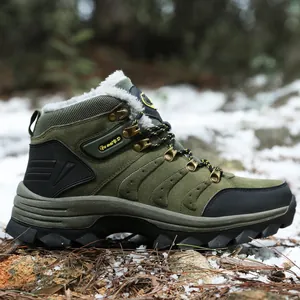 Close-up of olive green winter hiking boot with warm white faux fur lining in snow