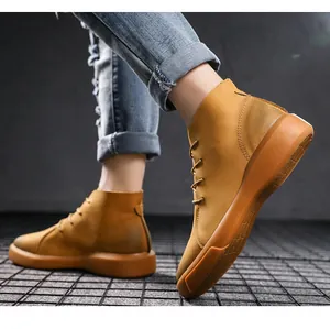 Close-up of men's tan leather high-top work boots featuring a durable rubber sole