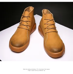 Close-up view of tan leather work boots with vintage distressed toe detail