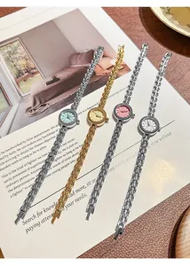 Vier elegante Vintage-Damenuhren mit kleinen runden Zifferblättern und Gliederkette