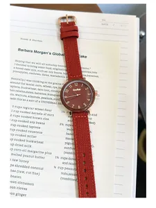 Minimalist women's quartz watch with terracotta canvas strap and brown dial detail