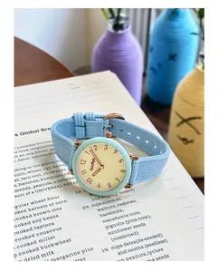 Minimalist aesthetic quartz watch for women with mint green bezel and blue strap