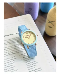 Minimalist blue fabric strap quartz watch with a cream dial and Arabic numerals by Gccliyo