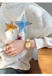 Close-up of the GCCLIYO minimalist quartz watch worn with a casual grey hoodie.