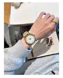 Detailed shot of a retro quartz watch featuring a yellow nylon strap and star-patterned dial