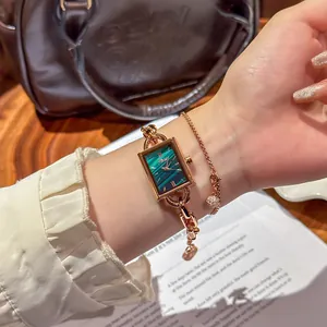 Elegant rose gold women's watch with green malachite dial and decorative chain strap