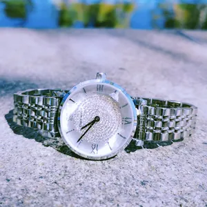 Close-up of GUOU women's quartz watch with sparkling rhinestone dial and steel strap