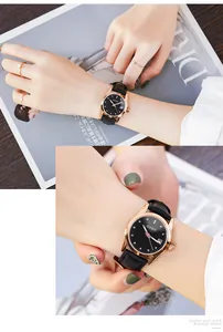 Close-up of GUOU women's leather watch with rhinestone markers and date display.