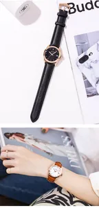 Close-up of GUOU women's leather strap watch with rhinestone markers and calendar display