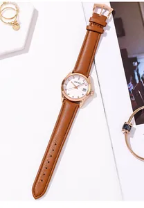 Close-up of GUOU women's watch featuring a brown leather strap and rose gold case