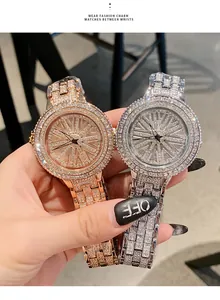 Detailed view of luxury iced-out women's quartz watches with a spinning turntable dial.