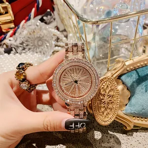 Luxury women's quartz watch with rhinestone encrusted rotating dial and rose gold band