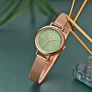 Close-up detail of a Kimio rose gold mesh strap watch with sage green floral dial pattern