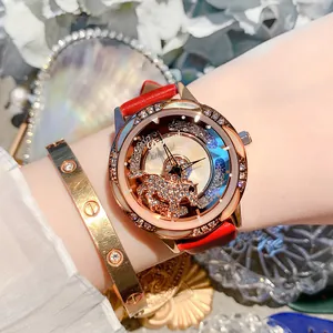Detailed view of an elegant ladies' watch with red leather strap and crystal accents.