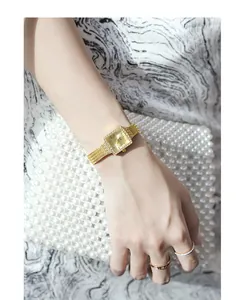 Detailed view of elegant square gold watch with rhinestone bezel and mesh strap