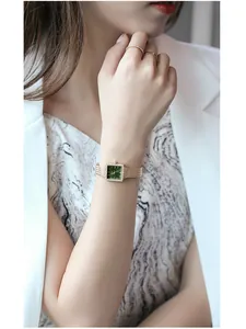 Elegant women's square quartz watch featuring a green dial and rhinestone bezel detail