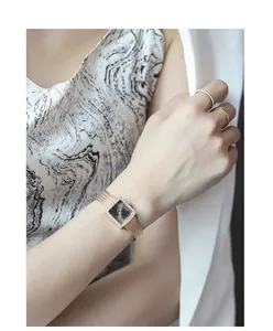 Elegant women's square quartz watch featuring a rhinestone bezel and luxury gold mesh band.