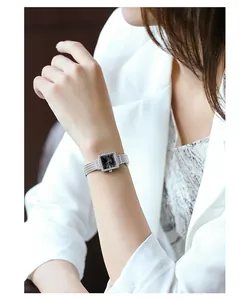 Elegant silver square quartz watch for women with rhinestone bezel shown on a wrist.