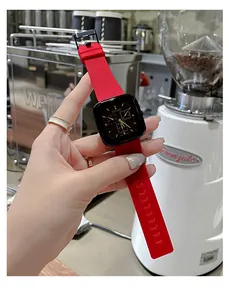 TICTOC square watch with black dial and red silicone strap worn in a cafe setting