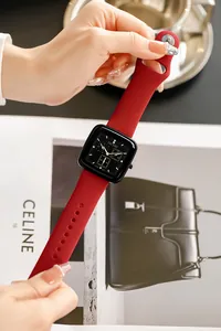 Close-up detail of a red silicone TICTOC watch featuring a square black multi-dial face