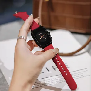 Close-up of minimalist GUOU square watch featuring a sleek red silicone strap and black dial
