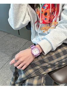 Detailed view of a purple square jelly quartz watch with silicone strap on wrist