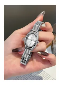 Close-up of GEDI silver oval quartz watch with flexible metallic strap for women.