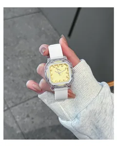 Close-up of a square white silicone strap quartz watch with a yellow dial