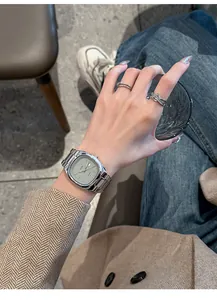Close-up of GEDI vintage silver steel band watch with rectangular dial on wrist