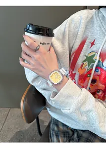 Lifestyle view of a women's square jelly quartz watch with white silicone strap.