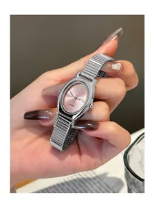 Elegant silver oval watch featuring a pink dial, displayed as a close-up on a stylish wrist