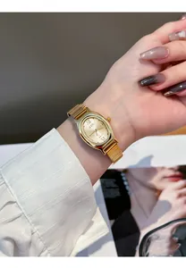 Detail showing a gold GEDI women's oval quartz watch with a mesh strap on the wrist