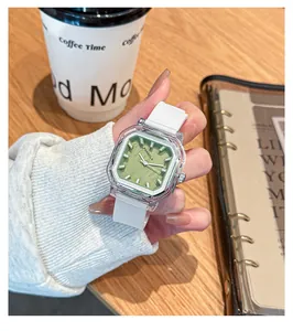 Macro view of a stylish square quartz watch featuring a green dial and white silicone strap