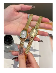 Detailed shot of two GEDI fashion oval quartz watches with golden stretch bands