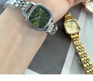 Close-up detail of a GEDI women's square quartz watch featuring a sunburst green dial